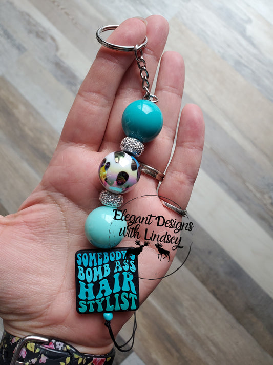 Somebody’s Bomb Ass Hairstylist (TURQUOISE) Silicone Keychain